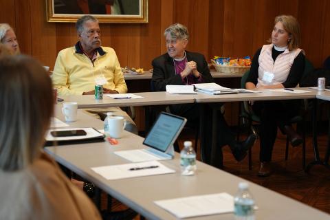 Episcopal and Presbyterian leaders sit around a table in the Mercer School of Theology