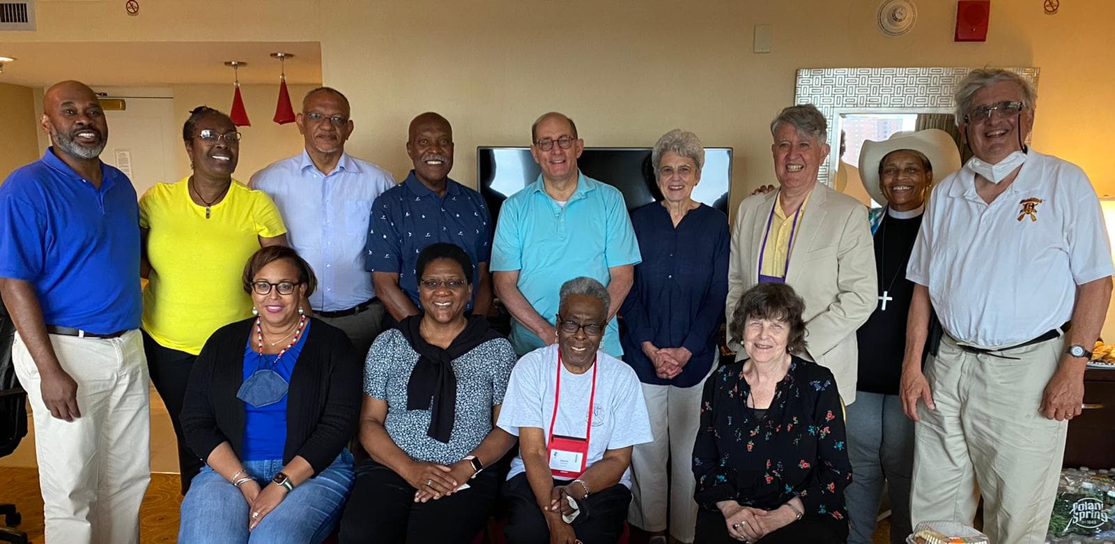 Deputies and Bishops of the Diocese of Long Island gather in the hospitality suite during the 80th General Convention. Front row: Sharon Brown-Veillard, Mo. Karen Davis-Lawson, Valerie Crosdale, Kathy Page. Back row: Fr. Hickman Alexandre, Linda Watson-Lorde, Fr. Donovan Leys, Fr. Tony Hinds, Bp. Larry Provenzano, Bp. Gerry Wolf, Bp. Bill Franklin, Cn. Lynn Collins, Charlie Janoff.