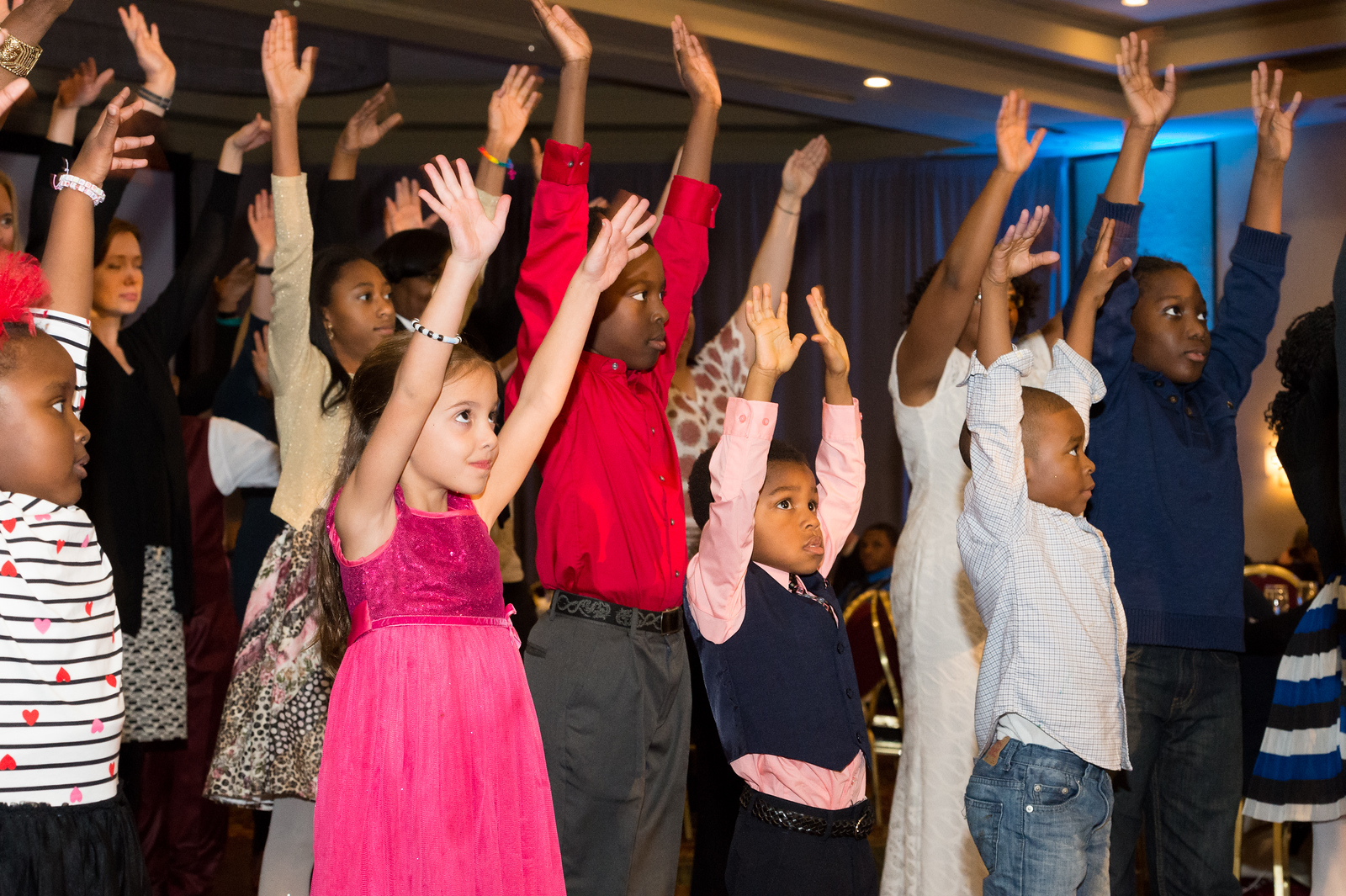 Children with their arms raised, dancing at 2016 Diocesan Convention