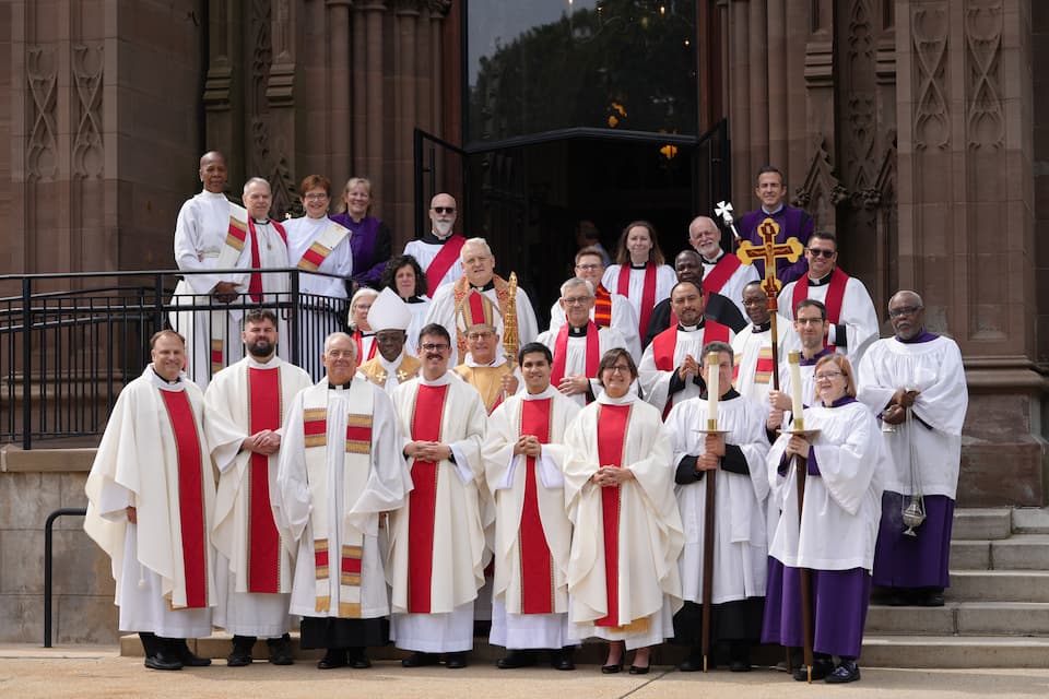 A group of clergy gather outside the Cathedral 