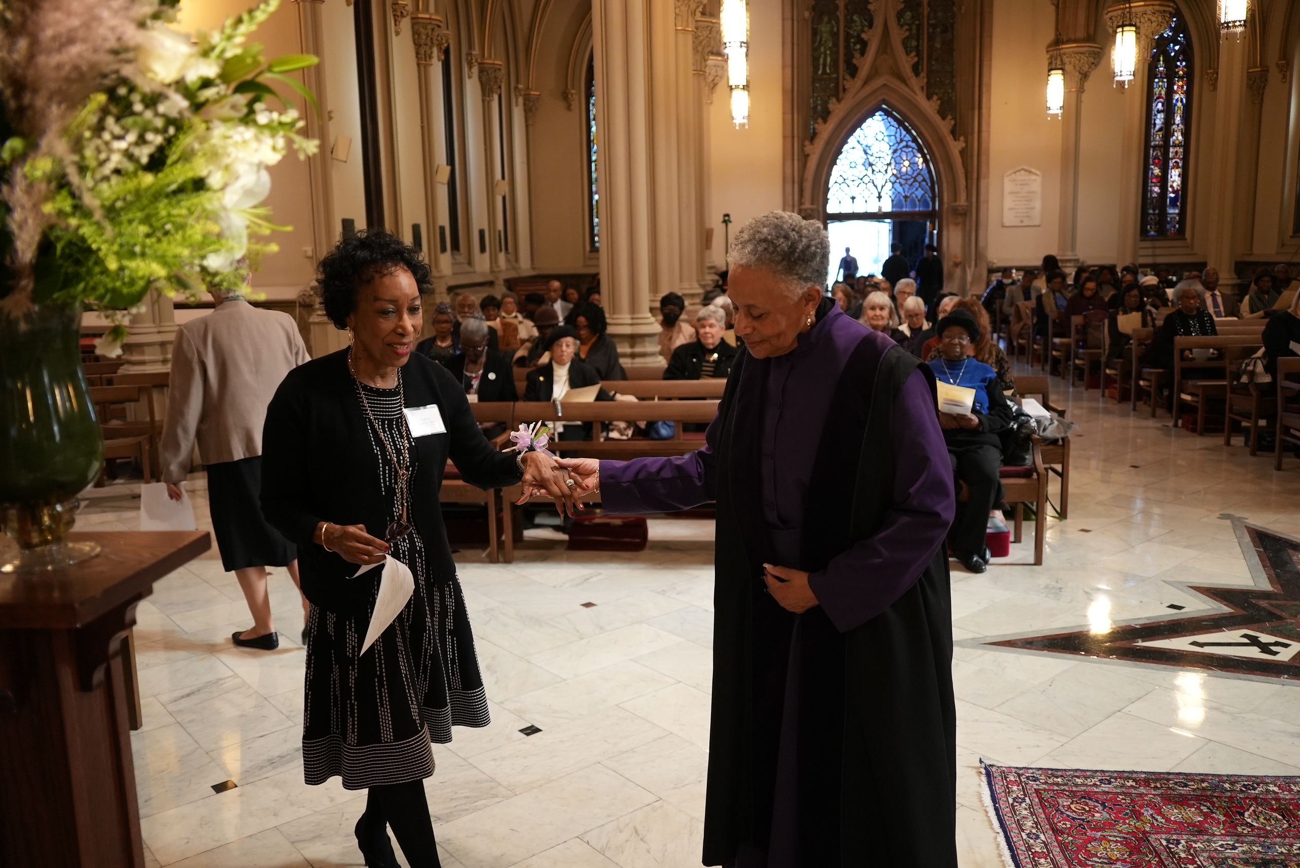 A verger leads a woman in the Cathedral