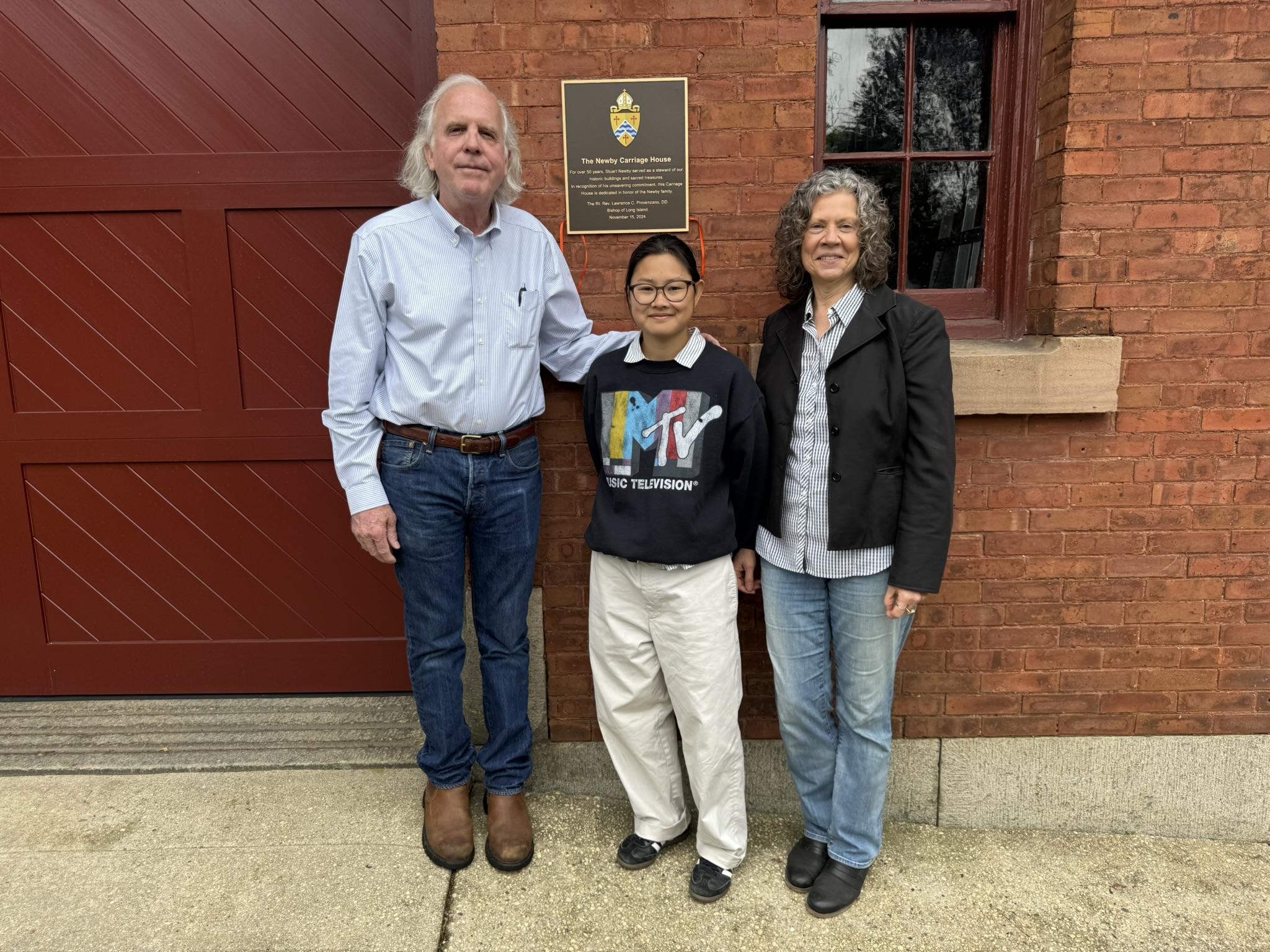 Stuart, Liann, and Catherine Newby in front of the Newby Carriage House