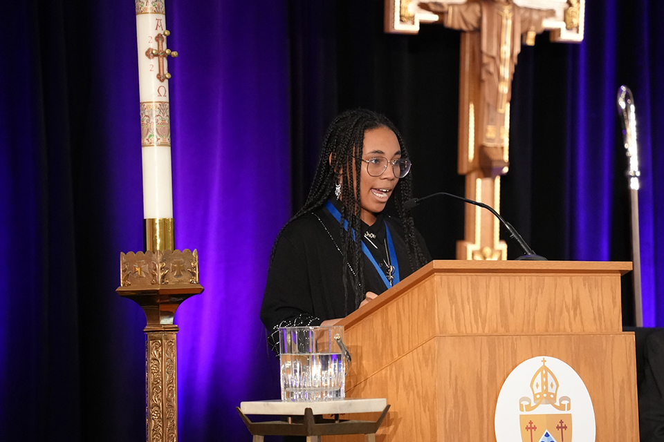 Young woman speaks at the podium at Convention