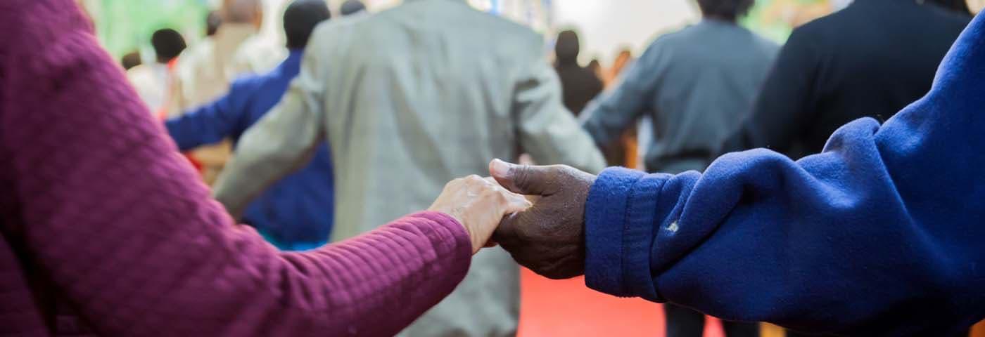Congregants holding hands 