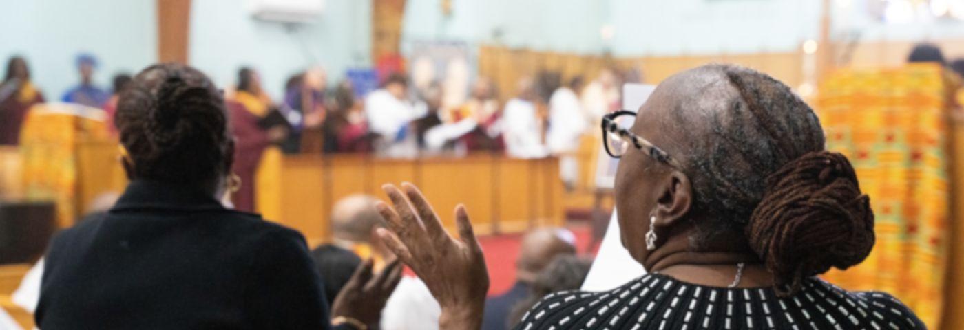Congregants clap in song
