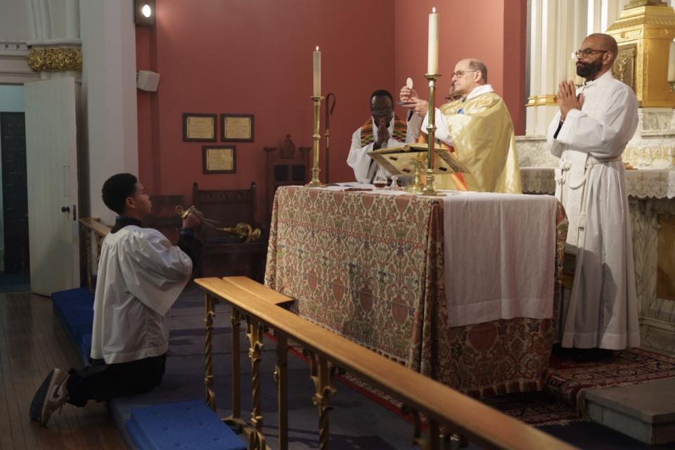 Acolyte swinging thurible during the elevation of the Eucharist