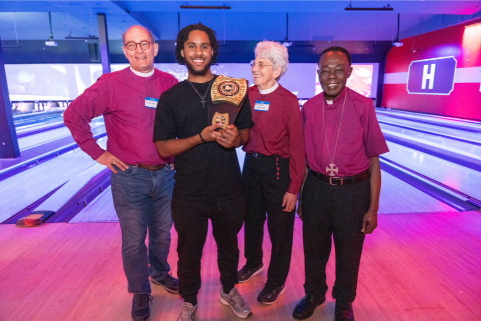 Trell from St. Gabriel's, Brooklyn poses with the bishops of Long Island after winning Bowling with the Bishops 2025