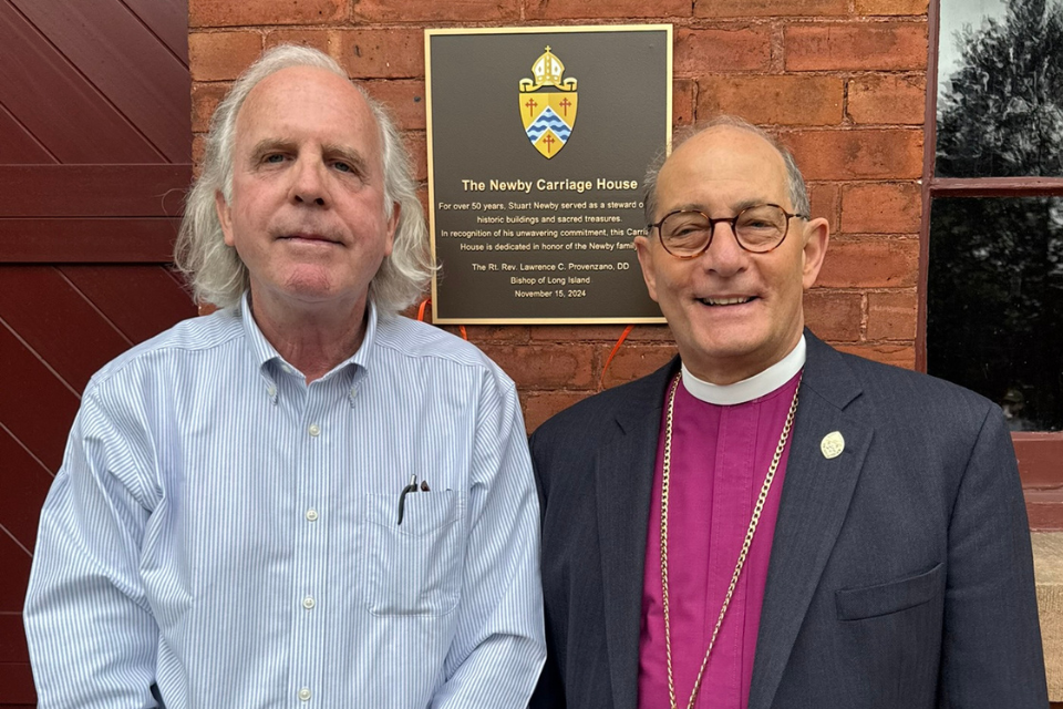 Stuart Newby and Bishop Provenzano stand in front of the newly dedicated Newby Carriage House