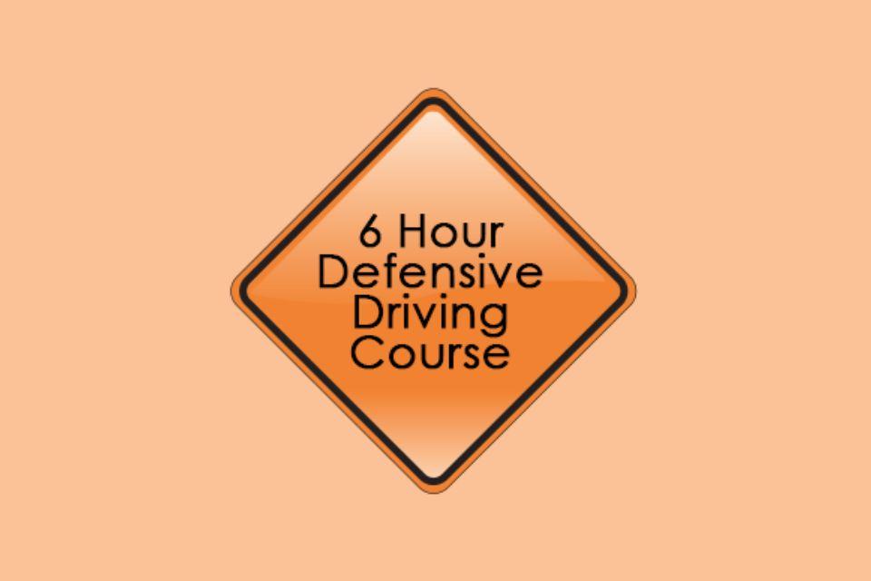 Diamond shaped orange sign with a black border. Text: "6 Hour Defensive Driving Course"