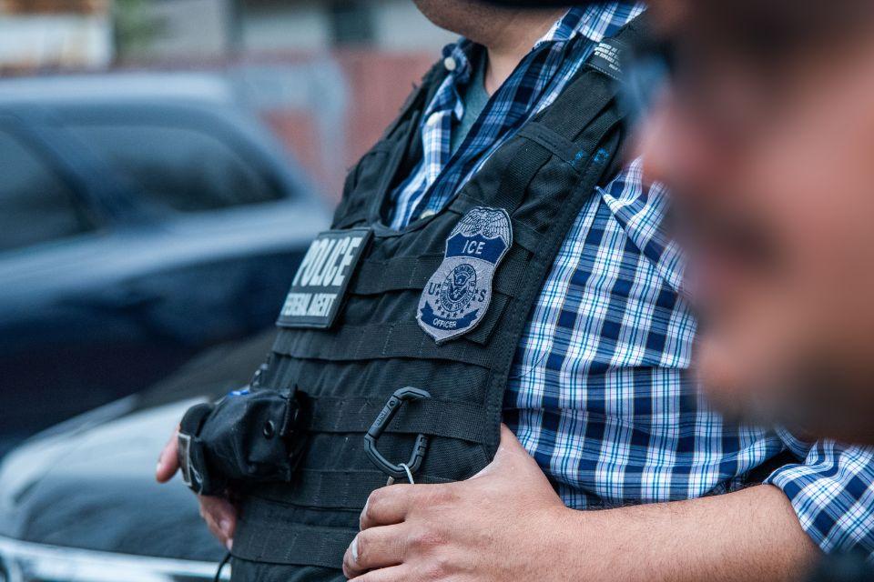 An ICE officer coordinates with other officials during an enforcement operation in San Antonio Feb. 5.