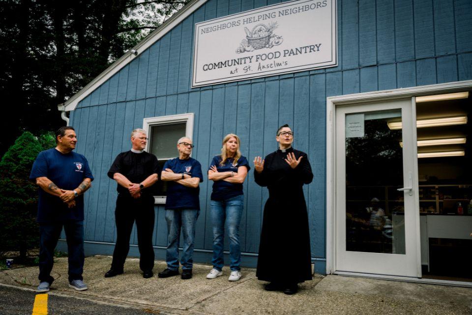 Clergy and lay leaders stand outside the Neighbors Being Neighbors Food Pantry (Photo: Girl in a Camera Productions)