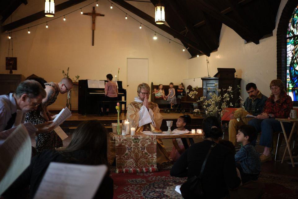 Congregants gather around Fr. Carl Adair at the altar 