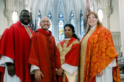 The four ordinands stand together in full Eucharistic vestments at the Cathedral of the Incarnation